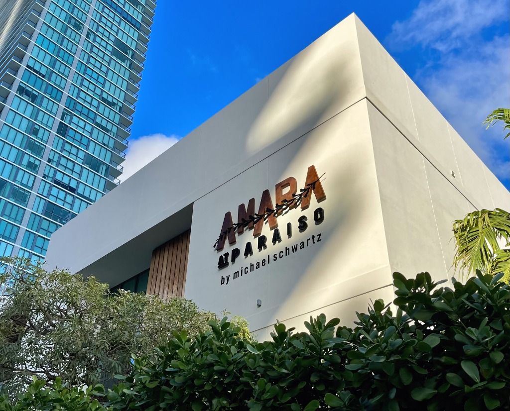 Modern white exterior building and architectural signage for Amara at Paraiso by Michael Schwartz along Biscayne Bay in Miami, Florida
