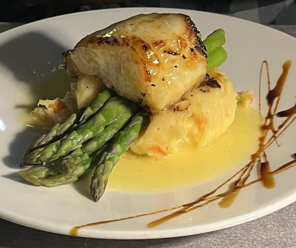 Pan-seared Chilean Sea Bass served over fresh green asparagus and mashed potatoes at Bistro 821 in Naples, Florida