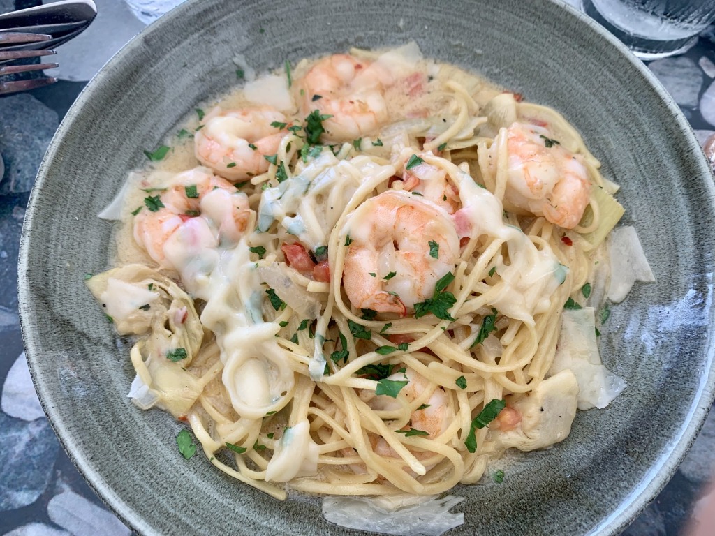 Creamy seafood scampi pasta with shrimp and artichoke hearts at Brimstone Woodfire Grill in Pembroke Pines, Florida
