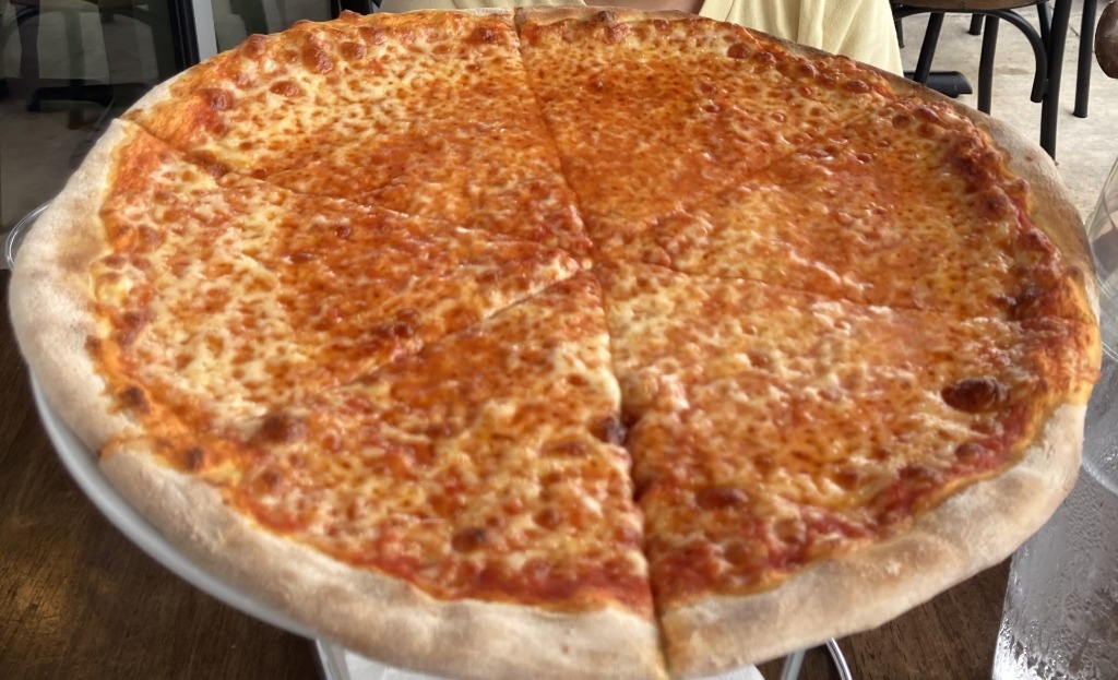 Cheese pizza cooked to golden brown at Mister O1 Extraordinary Pizza in Pembroke Pines, Florida