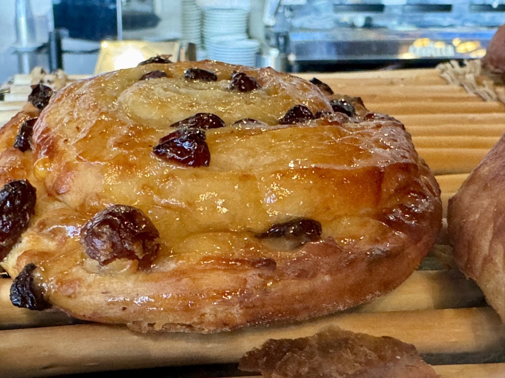 Traditional French pain aux raisins pastry close-up on a display counter at Paul Bakery in Sunrise, Florida