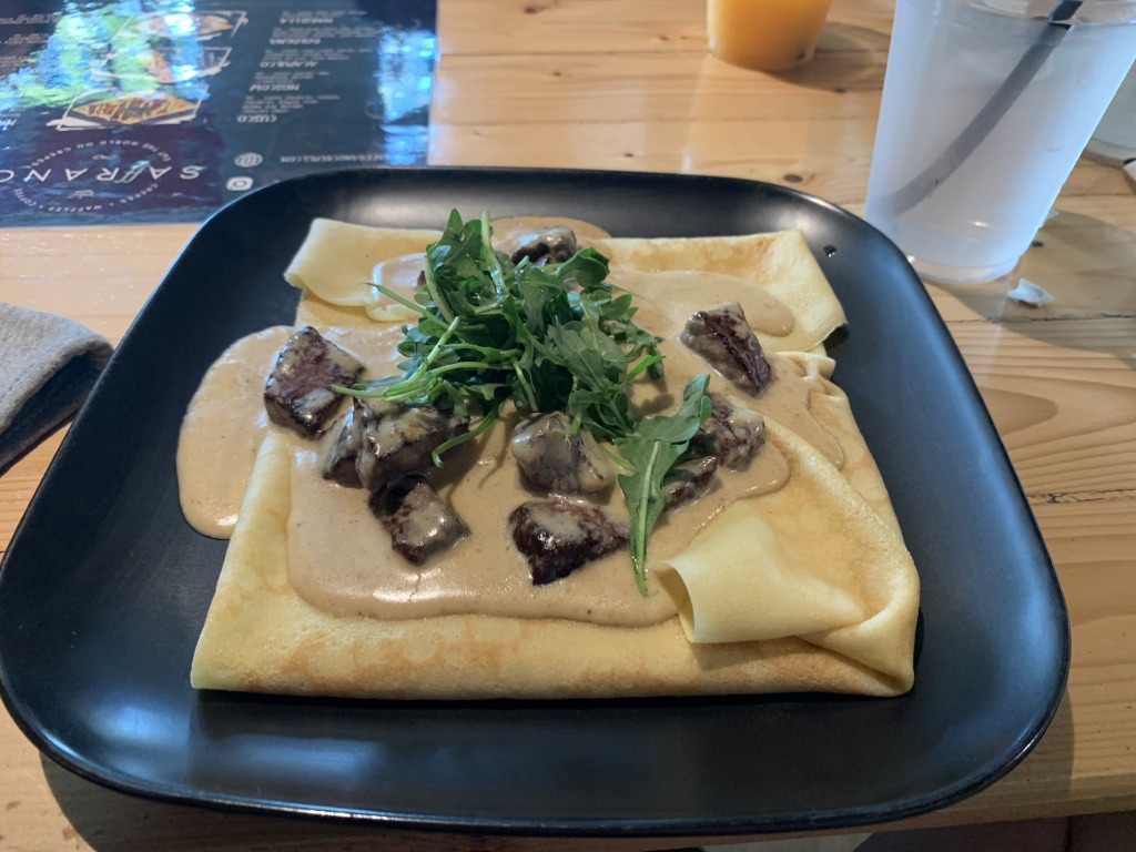 Savory crepe filled with steak, rich cream sauce, and fresh arugula at Saffrano Crepes & Coffee in Plantation, Florida
