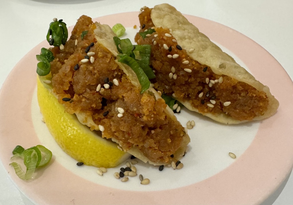 Crispy mini tuna tacos with guacamole, scallions, and spicy mayo served on a lemon wedge at Sushigami in Sawgrass Mills Sunrise, Florida