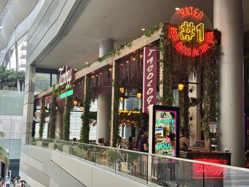 Lush garden terrace balcony under neon sign for Tacology at Brickell City Centre in Miami, Florida