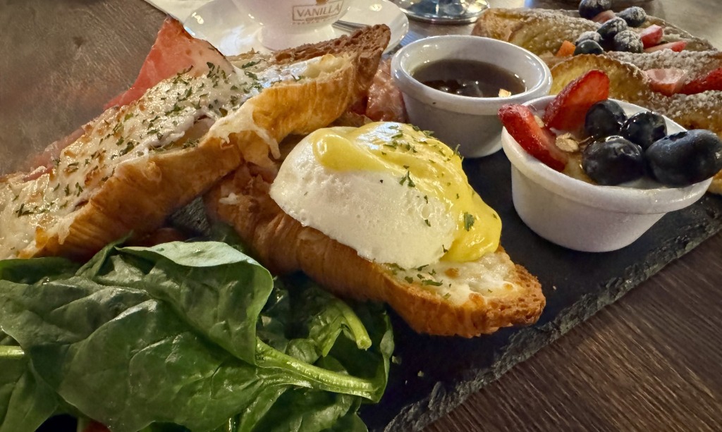 Bonjour Madam brunch board featuring croissant sandwiches, egg, homemade French toast, and fresh berries at Vanilla Espresso French Cafe in Miramar, Florida